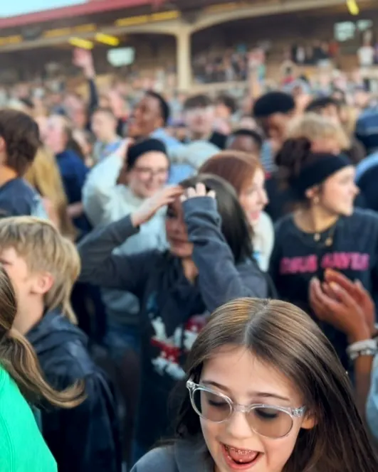 A student laughing in the crowd