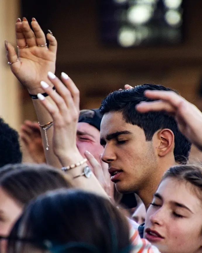 Students praying for each other during worship