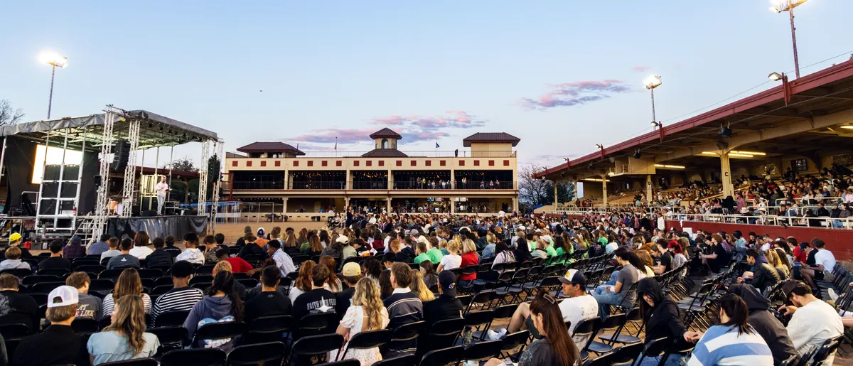 Students seated in rows at Norris Penrose as the sun goes down