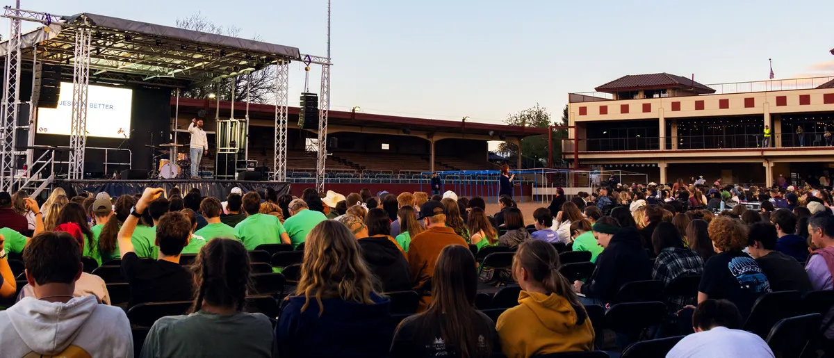 Youth groups seated together in front of the stage during the message